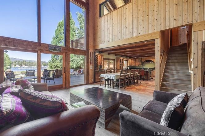 Great room with vaulted wood-beam ceilings and a wall of glass