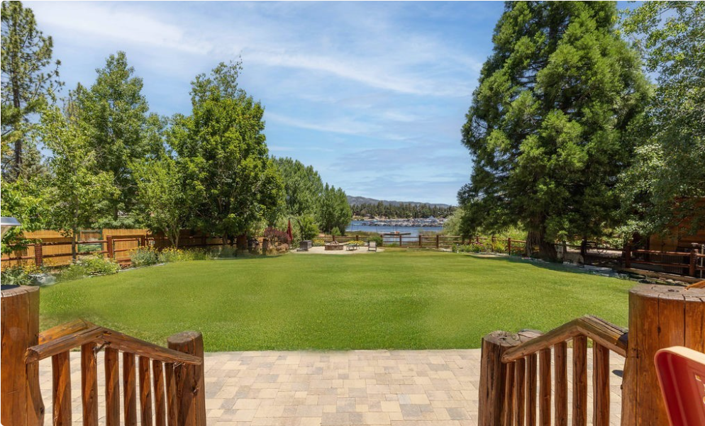 Sweeping grassy backyard leading down to the lake and marina